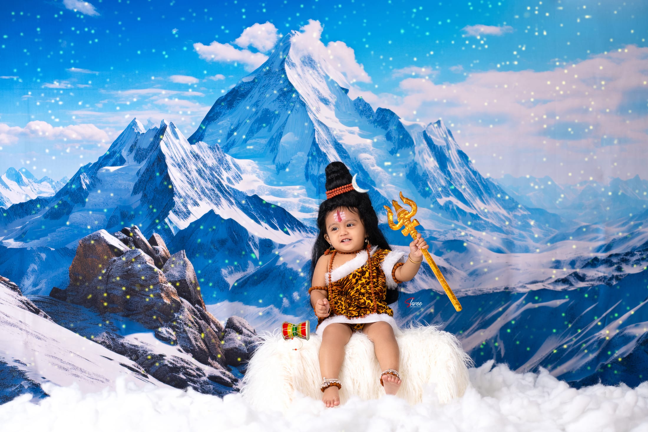 Baby in a themed mountain-cloud setup