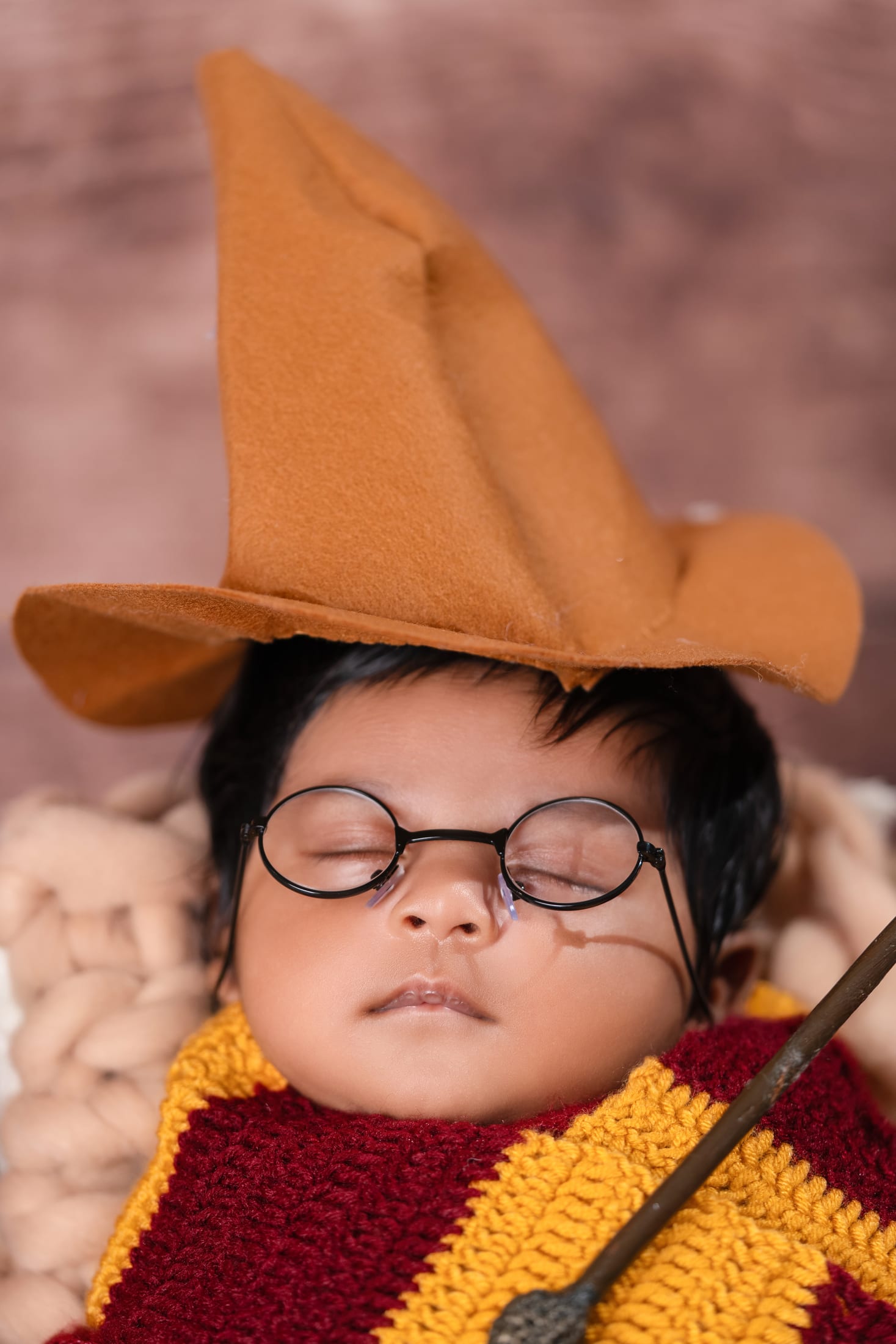 Baby in a playful wizard hat and glasses